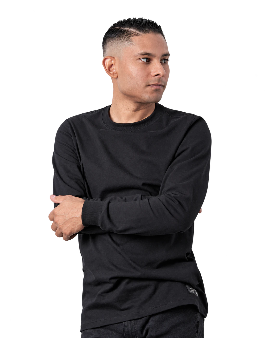 Bruno Stephen in a black top with arms crossed, looking to the side